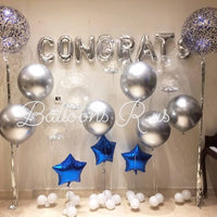 Graduation setup of chrome and confetti balloons